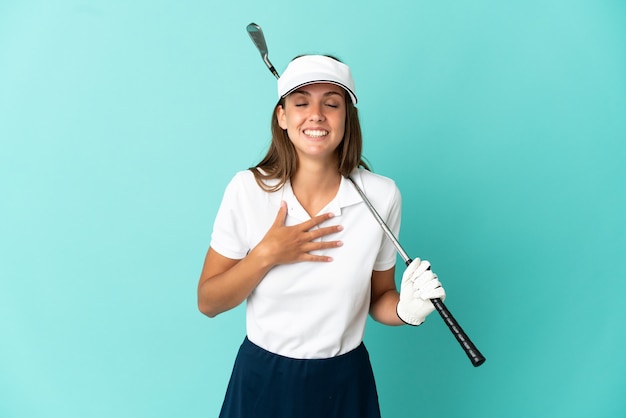 Vrouw golfen over geïsoleerde blauwe achtergrond veel glimlachen