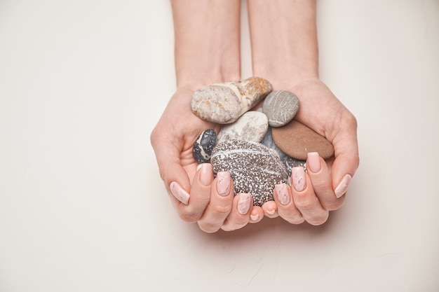 Vrouw handen met mooie manicure op lichte achtergrond