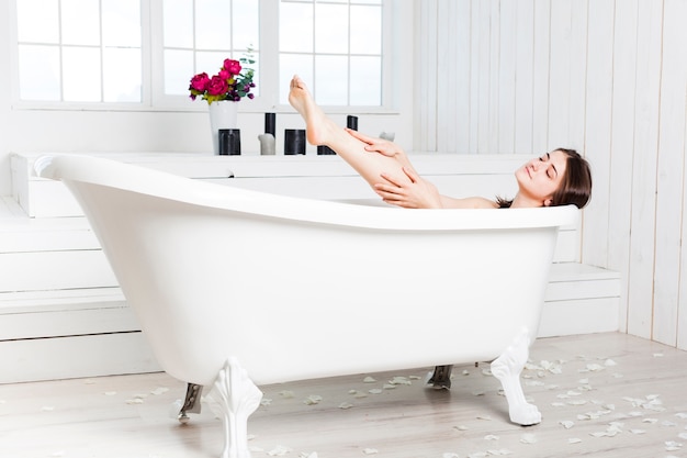 Foto vrouw het ontspannen in ton in elegante badkamers