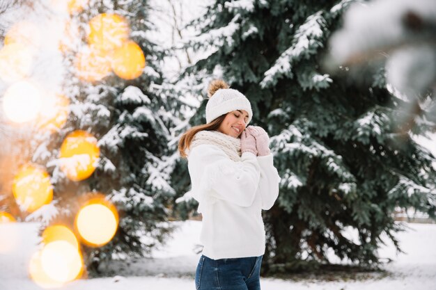 Vrouw het stellen in park met Kerstmislichten. Wintervakantie concept.