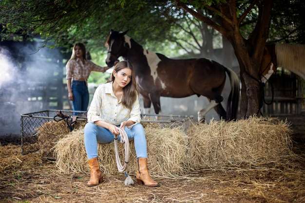 vrouw in cowgirl-stijl kostuum in een paardenranch met een westerse boerderijomgeving.