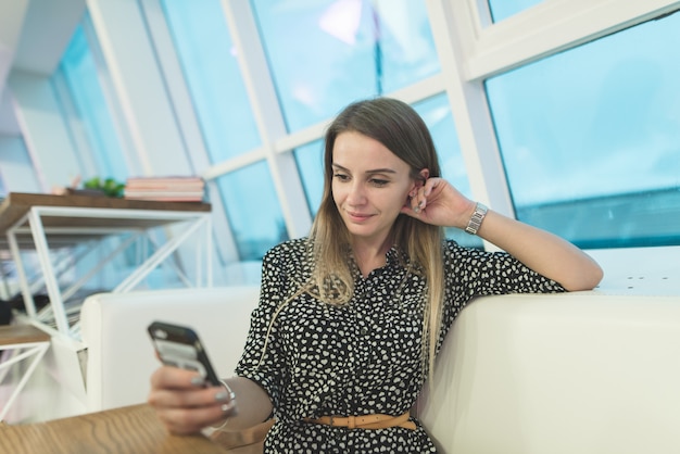 Vrouw in een casual jurk in een coffeeshop