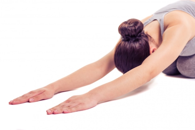 Foto vrouw in sportkleding die zich uitstrekt terwijl het doen van yoga.