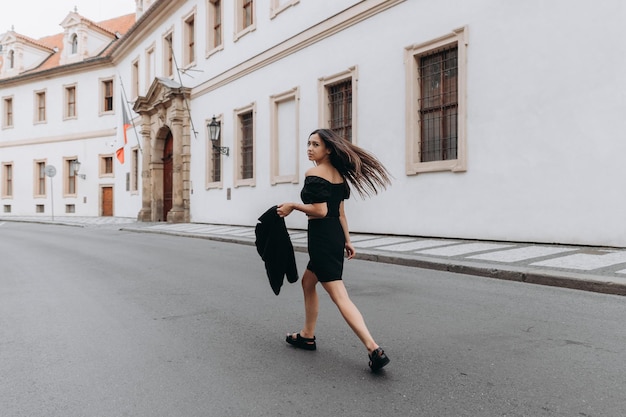 Vrouw in zwarte jurk wandelen in de oude stad Prague