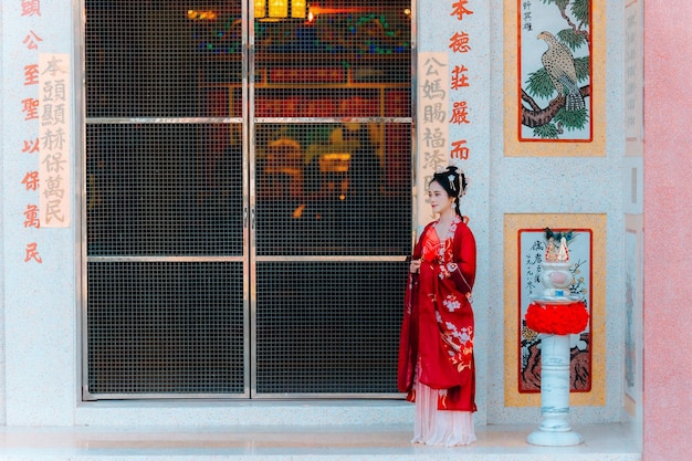 Foto vrouw jurk china nieuwjaars portret van een vrouw persoon in traditionele kostuum vrouw in traditionele kostum mooie jonge vrouw in een felrode jurk en een kroon van de chinese koningin poseren