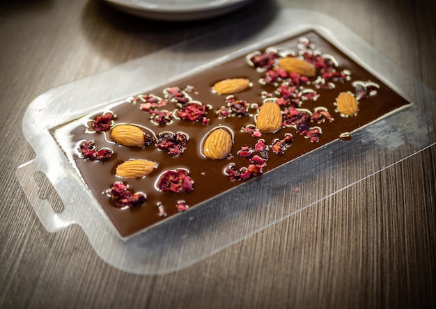 Foto vrouw koken smakelijke gesmolten chocolade op tafel in de keuken delicious dessert gemaakt van zelfgemaakte chocolade