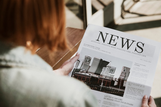 Vrouw leest een krant in een café