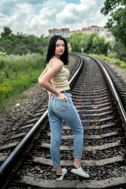 Foto vrouw lopen op de spoorlijn, zomer lifestyle reis