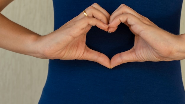 vrouw maakt handen in hartvorm hart ziektekostenverzekering sociale verantwoordelijkheid donatie