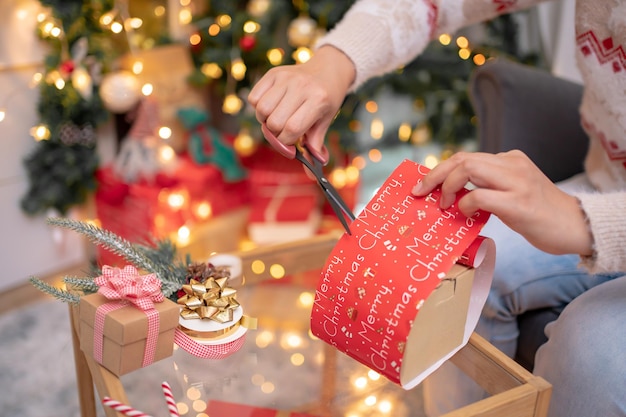 Vrouw met cadeau en cadeau voor kerst- en nieuwjaarsfeest thuis.