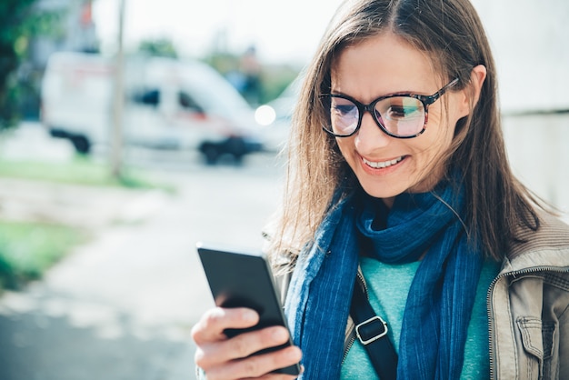 Vrouw met een mobiele telefoon op straat