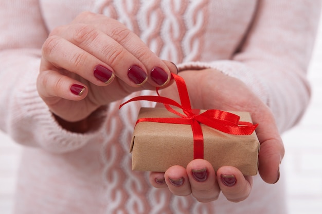 Vrouw met geschenkdoos met lint