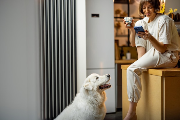 Vrouw met haar hond op keuken tijdens een ochtendtijd