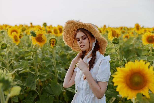Vrouw met hoed in een veld met zonnebloemen zomer natuur landschap
