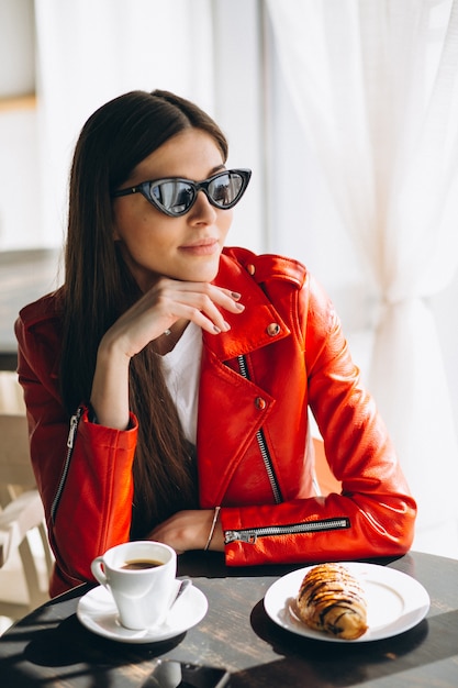 Vrouw met koffie en een croissant