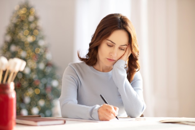 Vrouw met lang haar na te denken over haar werk