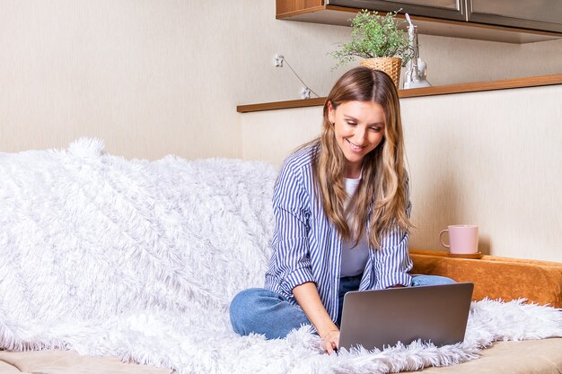 Vrouw met laptop die vanuit huis werkt