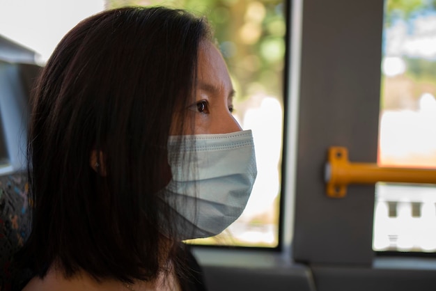 Vrouw met masker in een bus