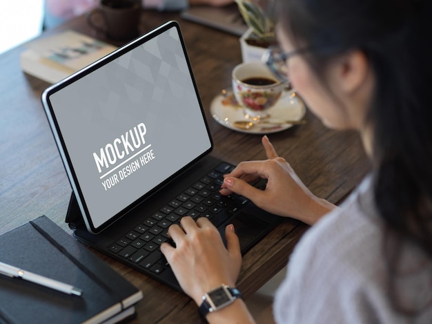 Foto vrouw met mobiele telefoon terwijl ze op tafel zit