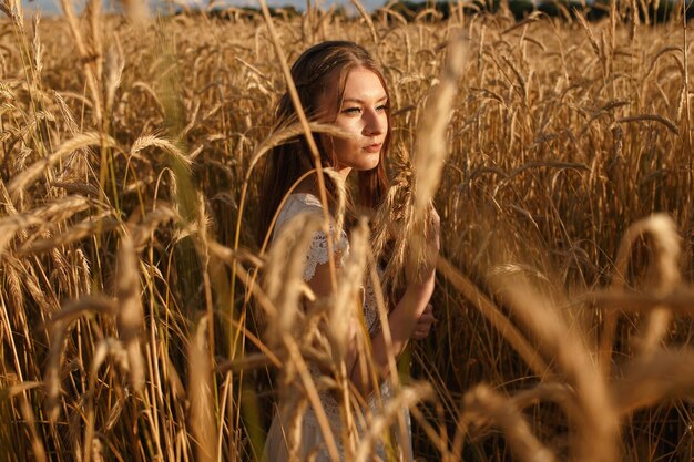 vrouw ontspannen in het tarweveld terwijl ze geniet van de natuur