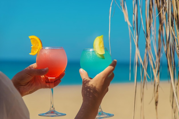 Vrouw op het strand met een cocktail in haar handen. Selectieve aandacht. Drankje.