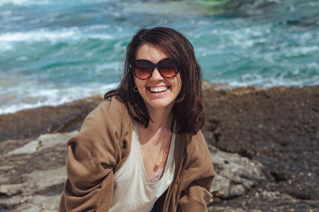 Vrouw op zee strand genietend van de kracht van de natuur winderig weer