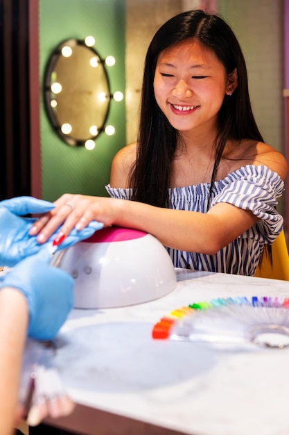 Vrouw probeert nagellakkleuren tijdens manicure