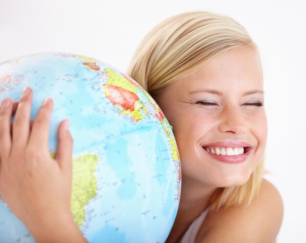 Foto vrouw reizen en de wereld omhelzen met studie en gelukkig van de aarde dag vakantie of internationale vakantie glimlachen wereld en kaart voor het leren en geografie met een vrouwelijke persoon en omhelzen van de planeet