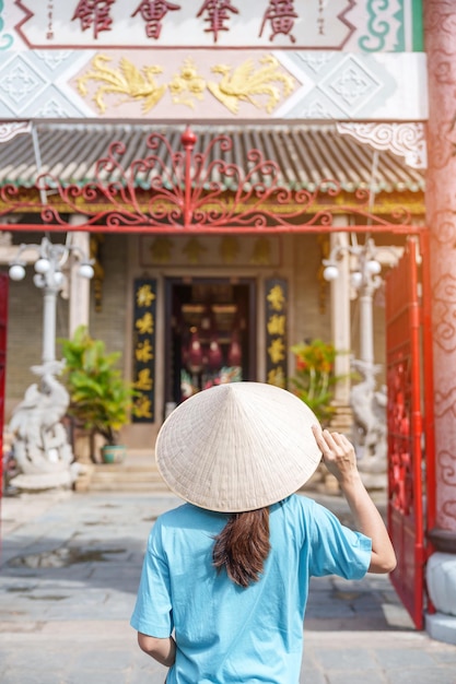 Vrouw reiziger sightseeing in Phouc Kien Assembly hall vertaling van Chinees karakter De oude gratie van 300 jaar oude architectuur Hoi An Vietnam en Zuidoost-Azië reisconcept