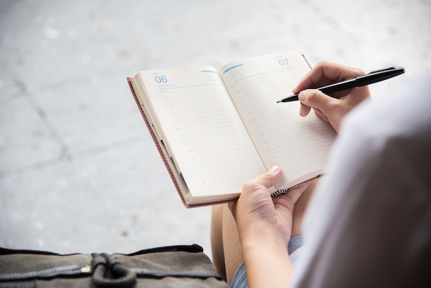 vrouw schrijven van notities in dagboek.