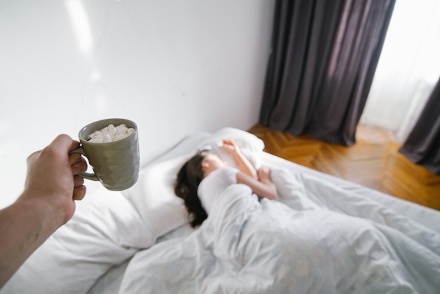 Vrouw slaapt in bed, zon dacht aan het raam