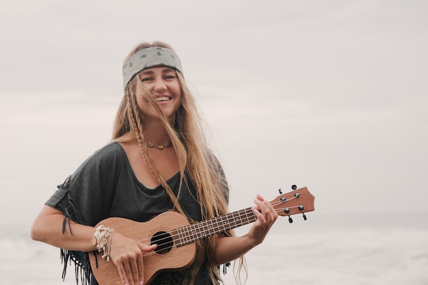 vrouw spelen ukulele op zee achtergrond