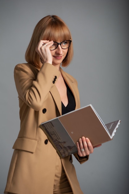 Vrouw van middelbare leeftijd met bril en boek