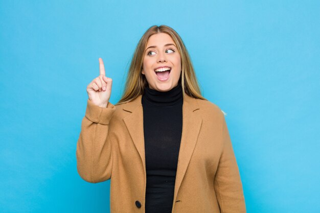 vrouw voelt zich een gelukkig en opgewonden genie na het realiseren van een idee, vrolijk opgestoken vinger, eureka!