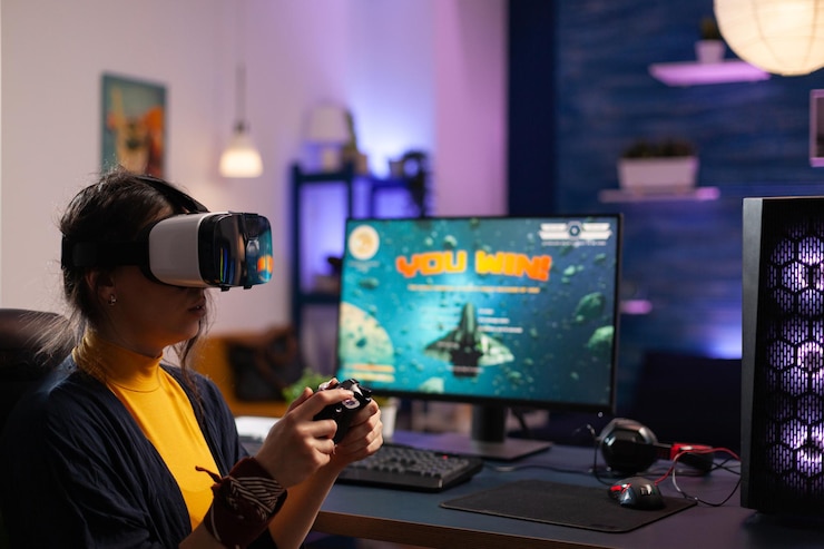 Foto vrouw winnende videospelletjes met vr-bril op computer. gamer speelt met virtual reality-headset en controller om online game op monitor te winnen. speler met moderne apparatuur aan de balie.