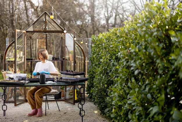 Foto vrouw zaait bloemen zaden in de achtertuin