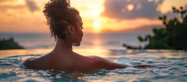 Foto vrouw zit in het water bij zonsondergang