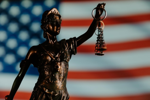 Vrouwe Justitia close-up met de vlag van de VS op de achtergrond