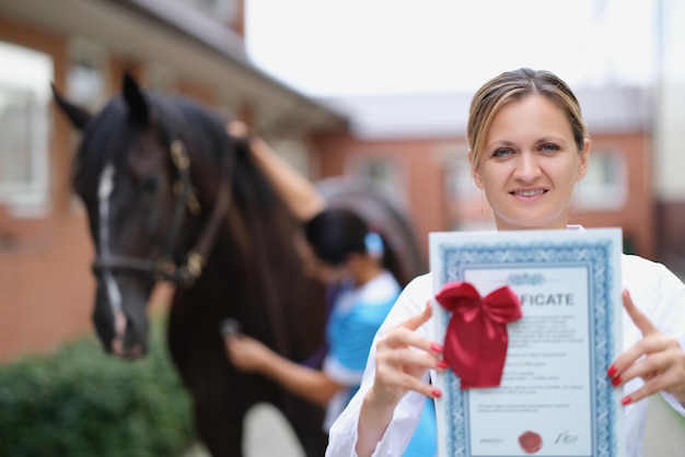 Vrouwelijke arts toont veterinair certificaat voor paarden