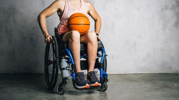 Vrouwelijke atleet in een rolstoel met een basketbal