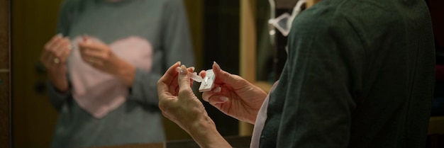 Vrouwelijke handen druipen zout testwater op een teststaafje van de coronavirus-thuistestkit
