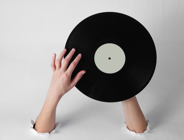 Foto vrouwelijke handen met een vinylplaat