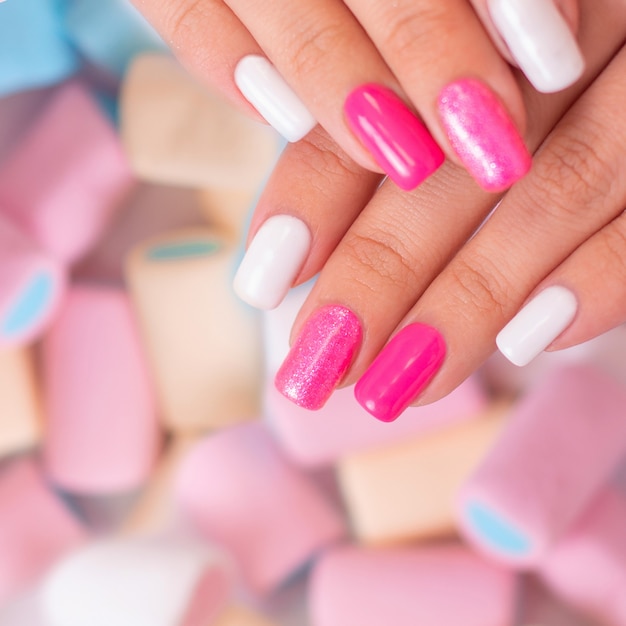 Vrouwelijke handen met veelkleurige manicure nagels