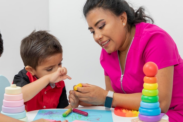 Vrouwelijke kinderarts arts die een kind controleert met een oximeter in haar medische kantoor