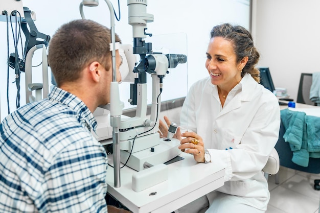 Vrouwelijke optometrist controleert het gezichtsvermogen van een patiënt in een kliniek