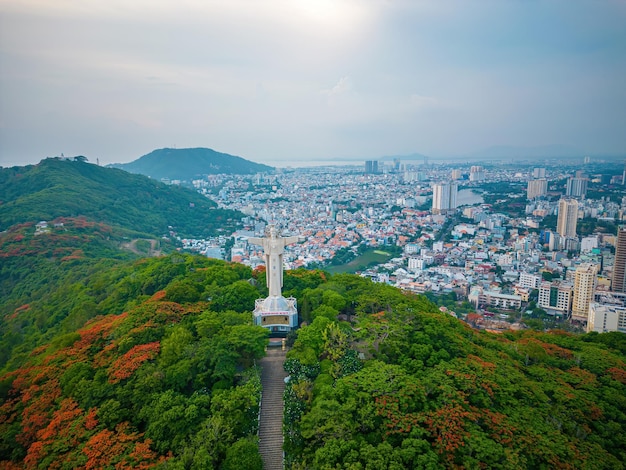 Vung Tau Viet Nam JUN 09 2022 Aerial view of Vung Tau with statue of Jesus Christ on Moutain the most popular local place Christ the King a statue of Jesus Travel concept