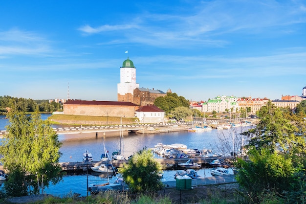 Vyborgkasteel en pijler met boten op zonnige dag Vyborg Rusland Augustus 2022