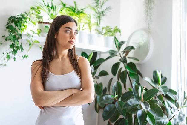 W looking away with white minimal background with green plants