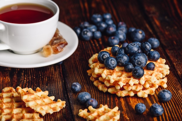 Foto wafels met bosbessen en kopje thee