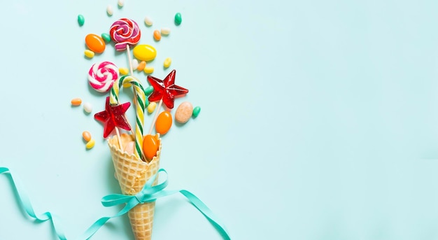 Wafer cone and candy on a blue background